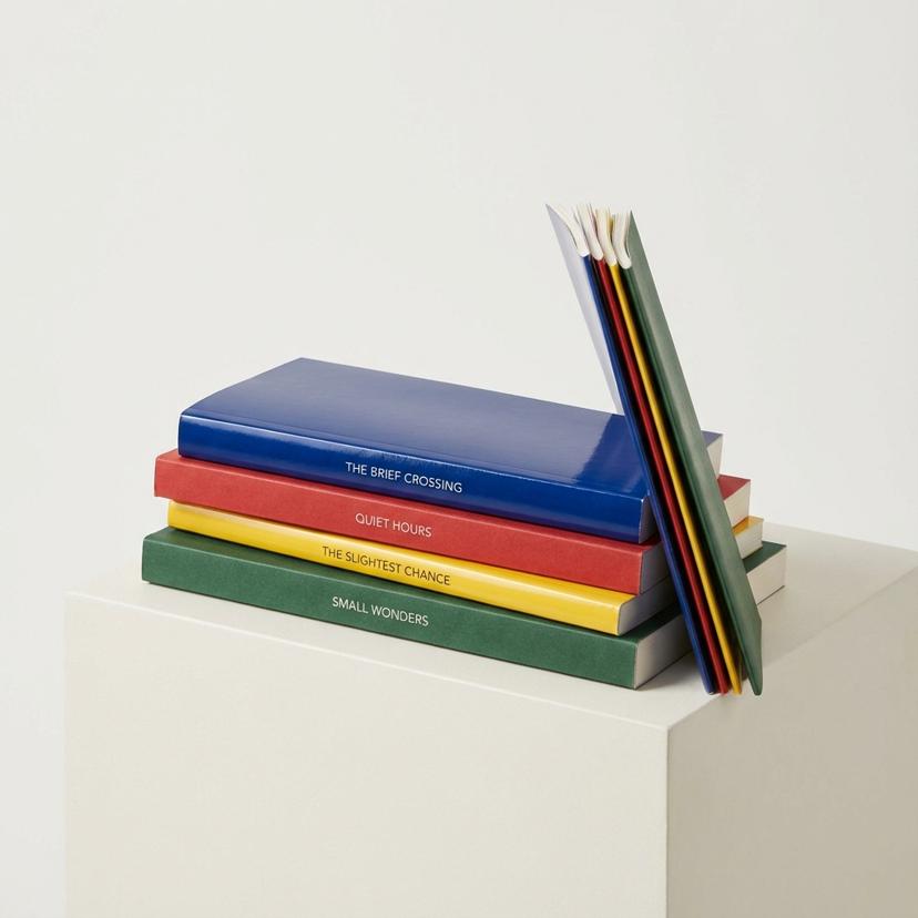 Slim paperback novels with colorful softcovers and thin spines